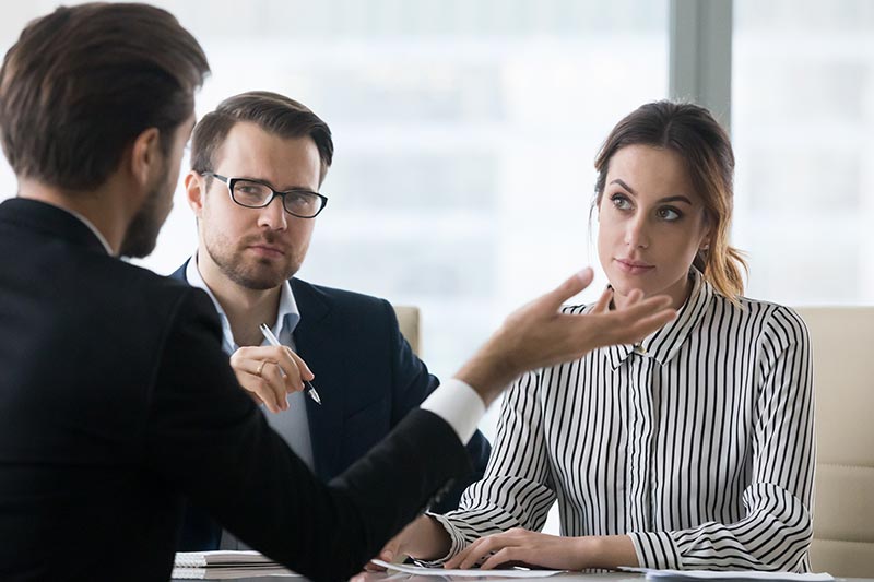 Buyers agent listening to sales agent during negotiation