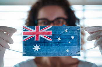 Woman showing COVID-19 surgical mask with Australian flag