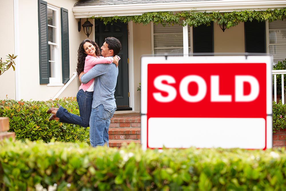 happy couple owning their dream house